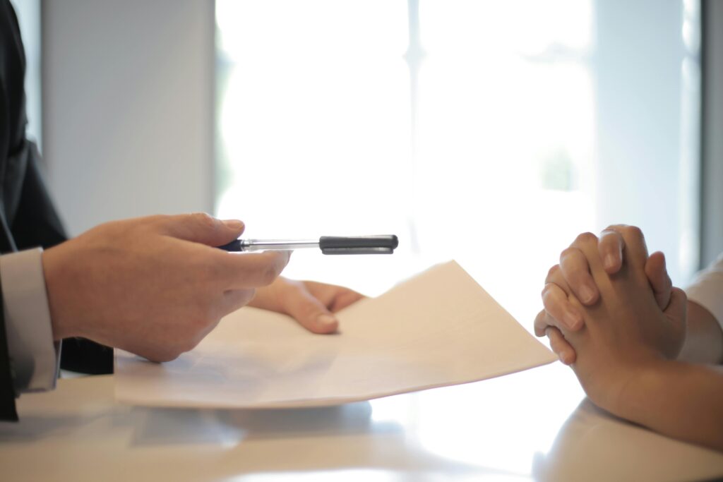 pexels-photo-3760067-3760067 Close-up of a contract signing with hands over documents. Professional business interaction.